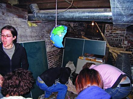 The audience gathered around a hanging globe piñata